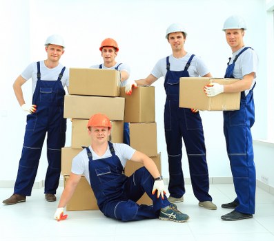 Professional movers packing household items for a London relocation