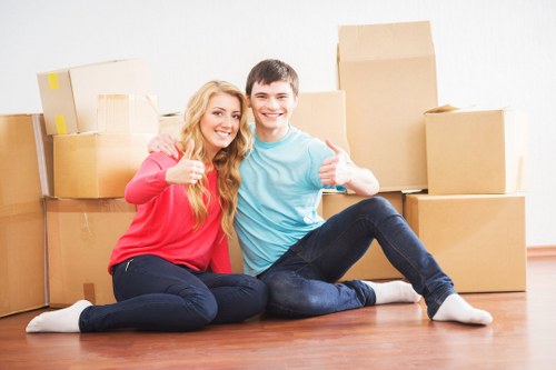Professional moving crew wearing PPE and handling items carefully